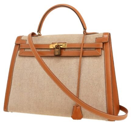 Hermès Kelly 35 cm handbag in gold Chamonix leather and beige canvas